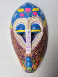 Adanne Ya – La hija de la madre, a hand-carved MASK-WE Gmelina wood mask painted by Faith Chidiogo Ifeanyichukwu