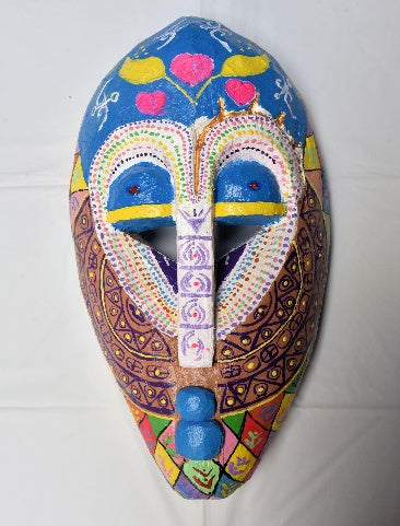 Adanne Ya – La hija de la madre, a hand-carved MASK-WE Gmelina wood mask painted by Faith Chidiogo Ifeanyichukwu